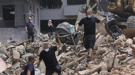 Residents of a building damaged in an Israeli airstrike return to collect their family's belongings at the site of Thursday's Israeli airstrike in Beirut, Lebanon, Saturday, Oct. 12, 2024. AP Photo/Hassan Ammar