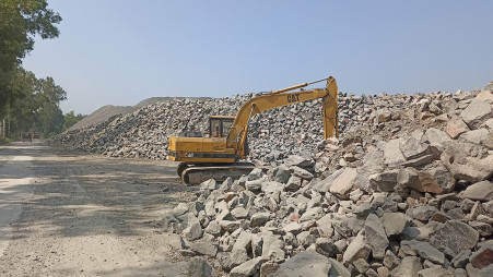 Piles of quarried stones are stored near the Madhyapara stone mine in Parbatipur, Dinajpur. The government mine has around 10 lakh tonnes of unsold granite worth Tk 300 crore because buyers prefer cheaper Indian stones which are easily available, October 28, 2024. Photo: Khorshed Alam/TBS 