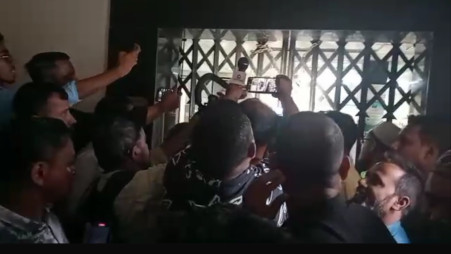 Customers, journalists outside the locked gate of the National Bank's Shibganj branch in Sylhet on October 30. Photo: Screenshot from a video