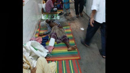 A patient lies on the floor of Dhaka Medical College and Hospital (DMCH). Photo: BSS