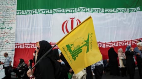 A woman holds a Hezbollah flag during a rally in support of Iran's Supreme Leader, Mojtaba Khamenei, in Tehran, Iran, 4 June, 2026. Majid Asgaripour/WANA (West Asia News Agency) via Reuters