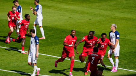 Football - FIFA World Cup 2026 - Group B - Canada v Bosnia and Herzegovina - Toronto Stadium, Toronto, Canada - 12 June, 2026 Canada's Cyle Larin celebrates scoring their first goal with teammates as Bosnia and Herzegovina's Tarik Muharemovic looks dejected IMAGN IMAGES via Reuters/Kevin Sousa