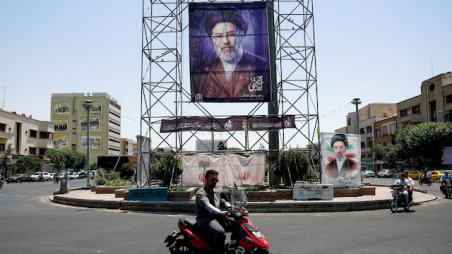 People ride past a banner with a picture of Iran's Supreme Leader, Mojtaba Khamenei, in Tehran, Iran, 28 June 2026. Photo: Reuters 