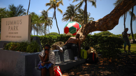 An inflatable soccer ball sits on Lummus Park as a man sleeps under a shaded tree amid a heat advisory in Miami Beach, Florida, U.S., June 17, 2026. Photo: Reuters