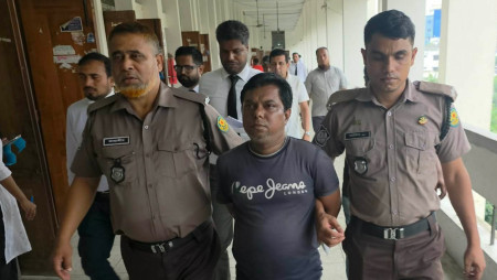 Accused Rashed Sarkar, a junior licensing inspector at the Civil Aviation Authority of Bangladesh (CAAB),is escorted by police at a Dhaka court today. Photo: Collected. 