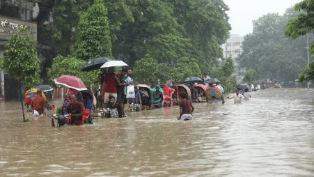 People wading through water after heavy rainfall in Azimpur, Dhaka. Photo: Rajib Dhar/TBS