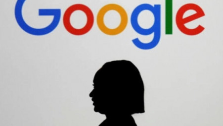 A woman walks by a giant screen displaying the Google logo at an event at the Paris Google Lab on the sidelines of the AI Action Summit in Paris, Feb. 9, 2025. Photo: AP