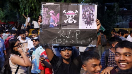 A supporter of India's Cockroach Janata Party (CJP) holds a poster with a Straw Hat Pirates' Jolly Roger symbol from the Japanese manga series 'One Piece' at the ongoing protest site, a few days after thousands of protesters marched towards parliament demanding the resignation of Education Minister Dharmendra Pradhan over National Eligibility cum Entrance Test (NEET) examination paper leaks, at Jantar Mantar in New Delhi, India, on 23 July 2026. Photo: Reuters