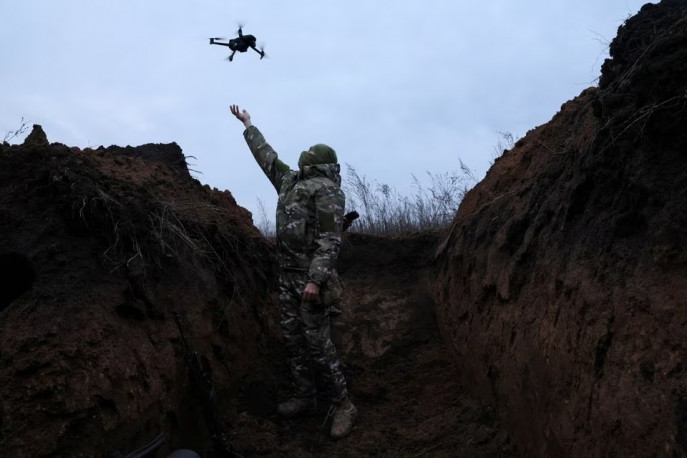 A soldier from the Ukrainian army's 58th Independent Motorized Infantry Brigade grabs a drone as he tests its use nearby.  The photo was taken near Bakhmut, Ukraine, on November 25, 2022. Photo: REUTERS