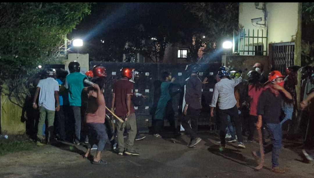 Men wearing helmets enter the JU VC's residence at midnight. Photo: Collected