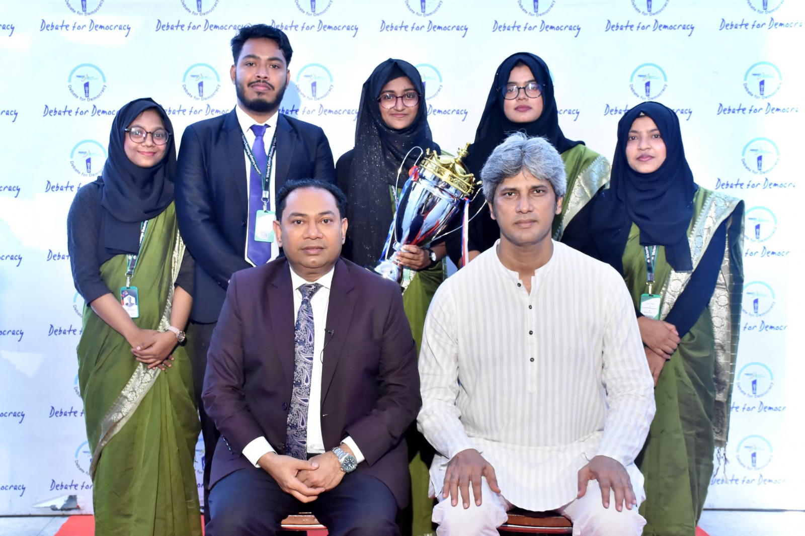 State Minister for Planning Zonayed Saki and Debate for Democracy Chairman Hassan Ahamed Chowdhury Kiron pose with members of the winning team after a shadow parliament debate on budget financing and implementation efficiency at BFDC in Dhaka, 27 June 2026. Photo: Courtesy