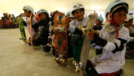 File photo of Afghan children holding their skateboards as they wait in line to take part in a skateboarding competition at Skateistan, a co-educational skateboarding school in Kabul on June 21, 2010. Photo: REUTERS