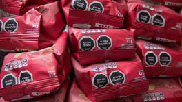 Food packages carry warning labels reading ‘High in Sodium’ and ‘High in Calories.’ The WHO considers warning-based front-of-package labelling an effective public health intervention and a "best buy" policy measure. Photo: EPA  
