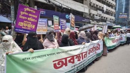 Protesters hold a human chain organized by account holders of Islami Bank in front of the bank's head office . The demonstrators demand the cancellation of the appointment of the bank’s chairman, alleging corruption, loan irregularities, and financial misconduct. Photo: Rajib Dhar