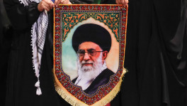 Women hold an image of Iran's late Supreme Leader Ayatollah Ali Khamenei as they walk to pay their respects near the coffins of Khamenei and his family members, on the day international delegates participate in a farewell ceremony for Khamenei, who was killed on February 28 during Israeli and US airstrikes on Iran, at the Imam Khomeini Grand Mosalla in Tehran, Iran on 3 July 3 2026. Photo: Reuters