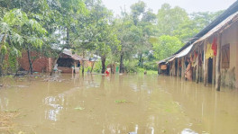 Residents wade through floodwater in Chattogram as water levels rise following days of heavy rain and upstream runoff. Photo: TBS