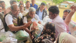State Minister for Power, Energy and Mineral Resources Aninda Islam Amit hands over relief packages for flood-affected people at the Chattogram Circuit House yesterday (13 July). Photo: TBS